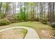 Expansive backyard with mature trees and landscape, perfect for recreation and relaxation at 204 Maple Creek Chase, Woodstock, GA 30188