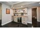Finished basement wet bar with stainless steel appliances, custom cabinets and lighting at 204 Maple Creek Chase, Woodstock, GA 30188