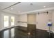 Finished basement featuring doors to the backyard, polished concrete floors and recessed lighting at 204 Maple Creek Chase, Woodstock, GA 30188