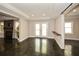 Finished basement showcasing a stone fireplace, doors to the backyard and polished concrete floors at 204 Maple Creek Chase, Woodstock, GA 30188
