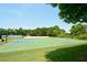 Brightly painted basketball court with volleyball net, mature trees, and well-maintained landscaping at 204 Maple Creek Chase, Woodstock, GA 30188