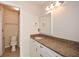 Bathroom featuring granite countertop, white cabinetry, and a shower with tiled walls at 204 Maple Creek Chase, Woodstock, GA 30188