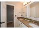 Bathroom featuring double sinks, granite countertops, and well-lit mirrors at 204 Maple Creek Chase, Woodstock, GA 30188