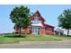 Charming red clubhouse with barn-style architecture, white trim, and lush landscaping at 204 Maple Creek Chase, Woodstock, GA 30188