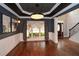 Spacious dining room features elegant lighting, dark wood floors, and natural light from the large window at 204 Maple Creek Chase, Woodstock, GA 30188