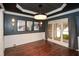 Elegant dining room boasts wainscoting, a striking chandelier, and a beautiful view of the outdoors at 204 Maple Creek Chase, Woodstock, GA 30188