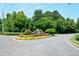 Attractive community entrance with lush landscaping and a prominent stone sign at 204 Maple Creek Chase, Woodstock, GA 30188