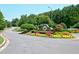 Well-maintained community entrance with stone signage and colorful landscaping at 204 Maple Creek Chase, Woodstock, GA 30188