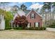 Elegant brick home with manicured landscaping, showcasing its classic design and inviting curb appeal at 204 Maple Creek Chase, Woodstock, GA 30188