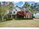 Charming two-story home with a combination of brick and siding, complemented by a lush, landscaped front yard at 204 Maple Creek Chase, Woodstock, GA 30188