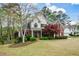 Beautiful two-story home featuring brick accents, a well-manicured lawn, and mature trees offering curb appeal at 204 Maple Creek Chase, Woodstock, GA 30188