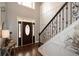 Grand foyer featuring hardwood floors, a staircase with iron railings, and a decorative front door at 204 Maple Creek Chase, Woodstock, GA 30188
