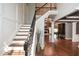 Inviting foyer with hardwood floors, a staircase, and an open view to adjacent living spaces at 204 Maple Creek Chase, Woodstock, GA 30188