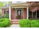 Elegant front entry with a decorative wood door, sidelights, and brick surround at 204 Maple Creek Chase, Woodstock, GA 30188