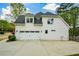 Side view of home featuring a spacious three car garage, ample parking, and manicured lawn at 204 Maple Creek Chase, Woodstock, GA 30188