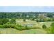 Scenic view of golf course with pond, fairway, and homes in the distance on a sunny day at 204 Maple Creek Chase, Woodstock, GA 30188