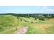 Scenic view of the rolling green golf course surrounded by mature trees and lush landscaping at 204 Maple Creek Chase, Woodstock, GA 30188