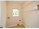 Clean and bright laundry room with shelving for organization and a window for natural light at 204 Maple Creek Chase, Woodstock, GA 30188