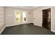 Finished living room with carpet, wainscoting and walkout to backyard through double doors at 204 Maple Creek Chase, Woodstock, GA 30188