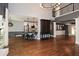 Open-concept living room with hardwood floors, modern furniture, and eat-in kitchen at 204 Maple Creek Chase, Woodstock, GA 30188