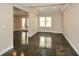 Spacious living room with polished concrete floors, tray ceiling, and natural light through a large window at 204 Maple Creek Chase, Woodstock, GA 30188