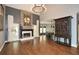 Open-concept living room with hardwood floors, fireplace, and elegant decor at 204 Maple Creek Chase, Woodstock, GA 30188