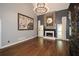 Spacious living room featuring a stone fireplace, hardwood floors, and modern chandelier at 204 Maple Creek Chase, Woodstock, GA 30188