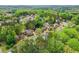 Aerial view of a lush, wooded neighborhood with well-spaced homes offering privacy at 204 Maple Creek Chase, Woodstock, GA 30188