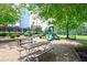 Playground with slides, picnic tables, shade trees and playground structures on a gravel surface at 204 Maple Creek Chase, Woodstock, GA 30188