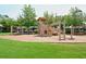 Playground with climbing structures, swings, slide, and mature trees on a mulch surface at 204 Maple Creek Chase, Woodstock, GA 30188