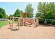Playground with climbing structures, swings, slides, and mature trees on a mulch surface at 204 Maple Creek Chase, Woodstock, GA 30188
