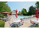 Resort-style pool area with lounge chairs, umbrellas, and a slide for endless summer fun at 204 Maple Creek Chase, Woodstock, GA 30188