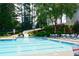 Inviting community pool featuring a slide, plenty of seating, and a relaxing atmosphere at 204 Maple Creek Chase, Woodstock, GA 30188