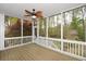 Relaxing screened porch with ceiling fan, perfect for enjoying the outdoors at 204 Maple Creek Chase, Woodstock, GA 30188