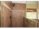 Walk-in shower features earth tone tile and a glass enclosure at 204 Maple Creek Chase, Woodstock, GA 30188