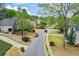 A residential street scene showcases a peaceful neighborhood with mature trees and well-kept homes at 204 Maple Creek Chase, Woodstock, GA 30188