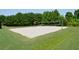Outdoor sand volleyball court, ready for friendly games, surrounded by lush green lawn and trees at 204 Maple Creek Chase, Woodstock, GA 30188