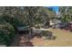 An aerial view showing a large yard, carport, and surrounding trees and landscaping at 2533 Whispering Pines Dr, Grayson, GA 30017