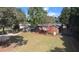 Aerial view of a well-maintained brick home with spacious yard, mature trees, and outbuilding at 2533 Whispering Pines Dr, Grayson, GA 30017