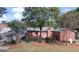 Exterior shot showcasing a brick home with a shed and expansive green lawn at 2533 Whispering Pines Dr, Grayson, GA 30017