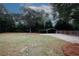 Spacious backyard with mature trees and covered parking at 2533 Whispering Pines Dr, Grayson, GA 30017