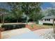 Scenic backyard featuring landscaping, a brick path, gravel feature, and a detached garage at 2533 Whispering Pines Dr, Grayson, GA 30017