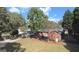 Backyard view showing a brick home with a lush lawn, shed, and mature trees at 2533 Whispering Pines Dr, Grayson, GA 30017