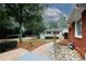 Spacious backyard featuring a brick pathway, a tidy lawn, landscaping rocks and gravel features at 2533 Whispering Pines Dr, Grayson, GA 30017
