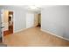 View of a bright bedroom with neutral walls and carpet, featuring a closet and an open doorway at 2533 Whispering Pines Dr, Grayson, GA 30017