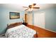 Bedroom featuring hardwood floors, blue walls, a ceiling fan, and a full-size bed at 2533 Whispering Pines Dr, Grayson, GA 30017