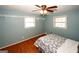 Bedroom with hardwood floors, a ceiling fan, blue walls and built-in shelving at 2533 Whispering Pines Dr, Grayson, GA 30017