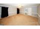 Large bedroom with neutral walls and carpet, a ceiling fan, and access to an ensuite bathroom at 2533 Whispering Pines Dr, Grayson, GA 30017