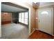 The carpeted living room with large windows is adjacent to a tiled entryway and dining room at 2533 Whispering Pines Dr, Grayson, GA 30017