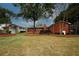 Brick home with an expansive lawn and mature landscaping offering a serene outdoor setting at 2533 Whispering Pines Dr, Grayson, GA 30017